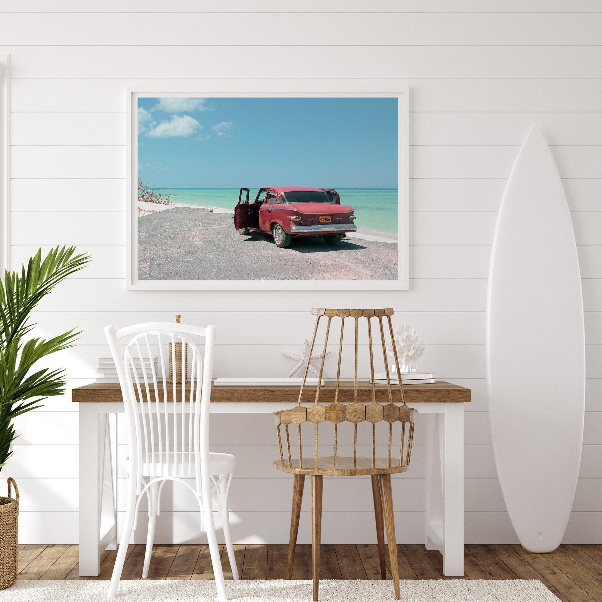 A fine art beach print with a vintage car in front of a turquoise ocean beach.