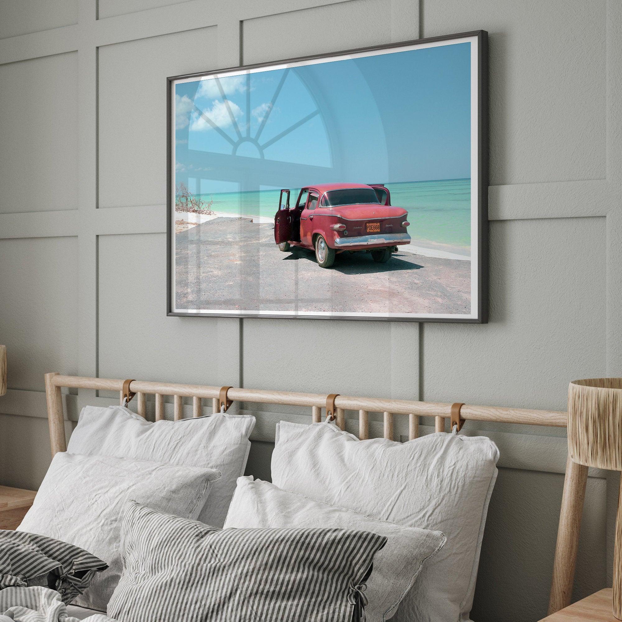 A fine art beach print with a vintage car in front of a turquoise ocean beach.