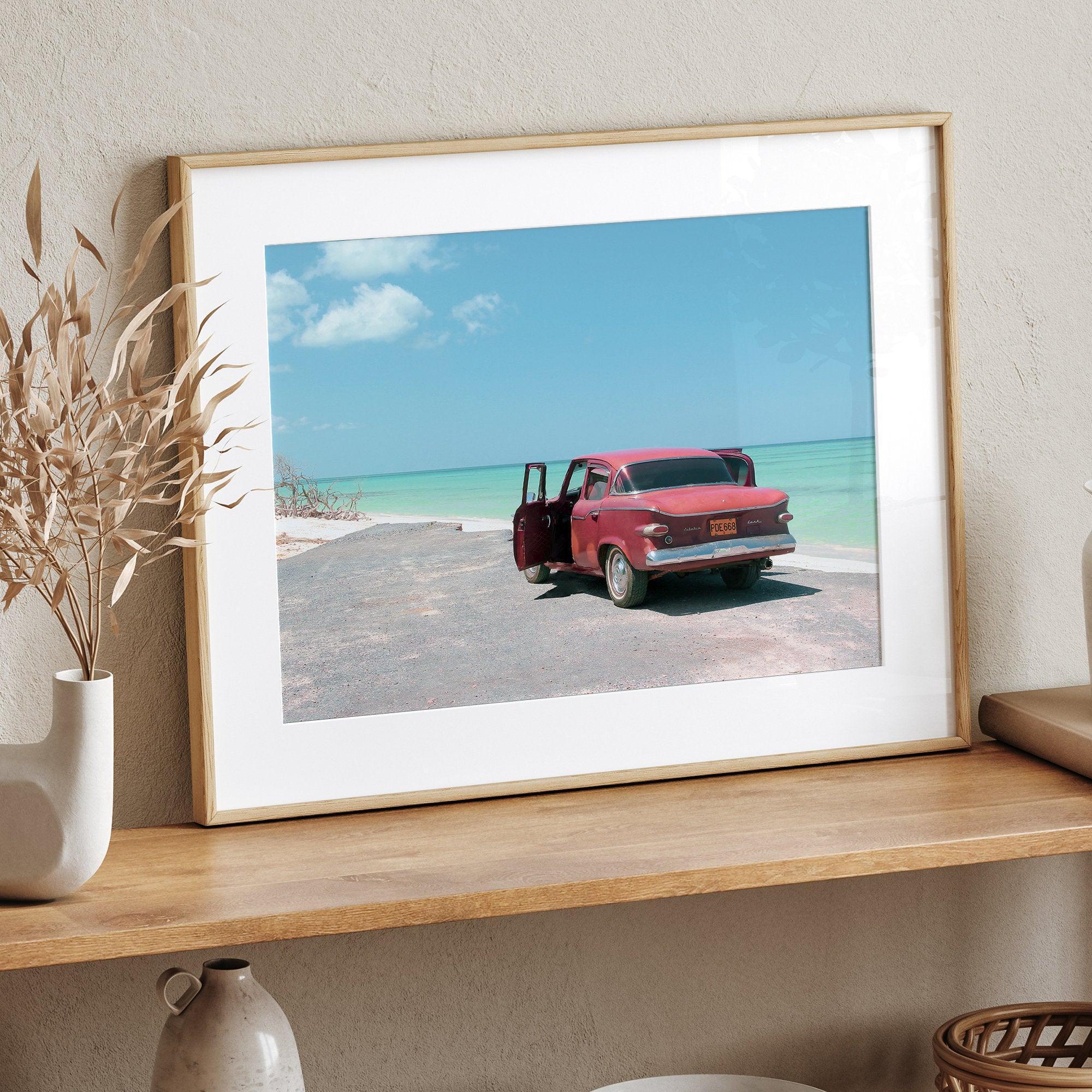 A fine art beach print with a vintage car in front of a turquoise ocean beach.