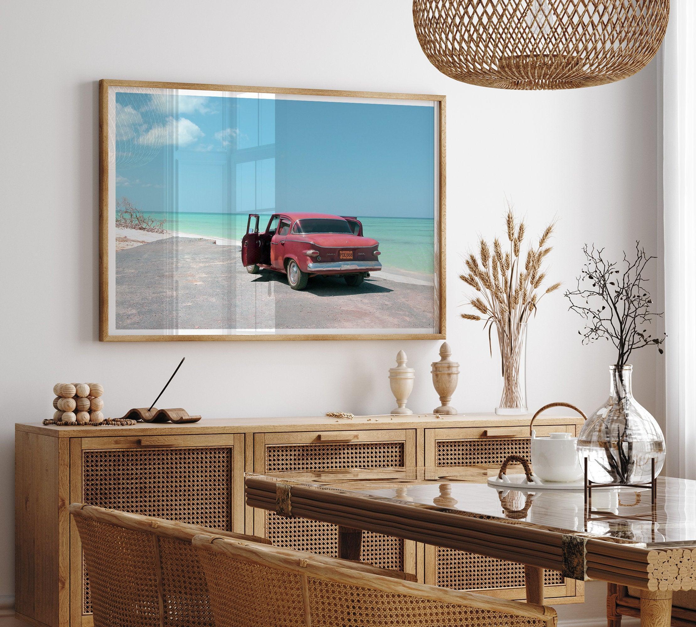 A fine art beach print with a vintage car in front of a turquoise ocean beach.