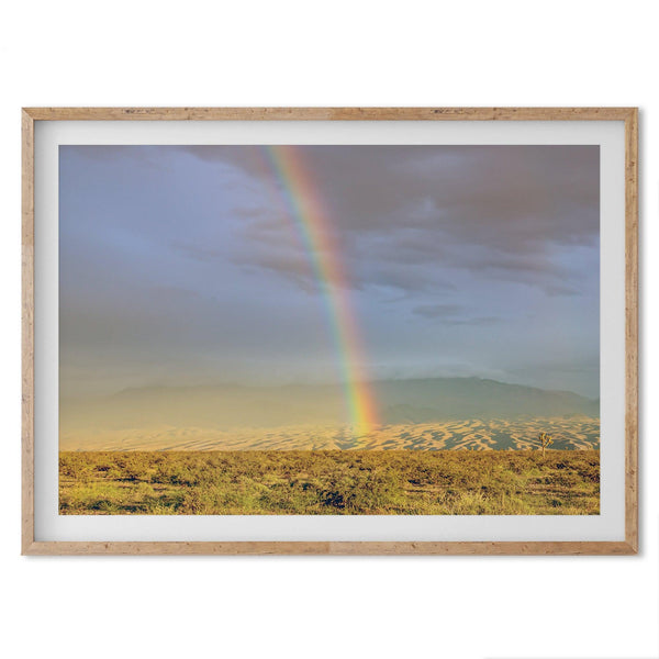 A fine art unframed or framed Arizona desert print showcasing a beautiful rainbow and cloudy sky in the middle of the desert landscape.