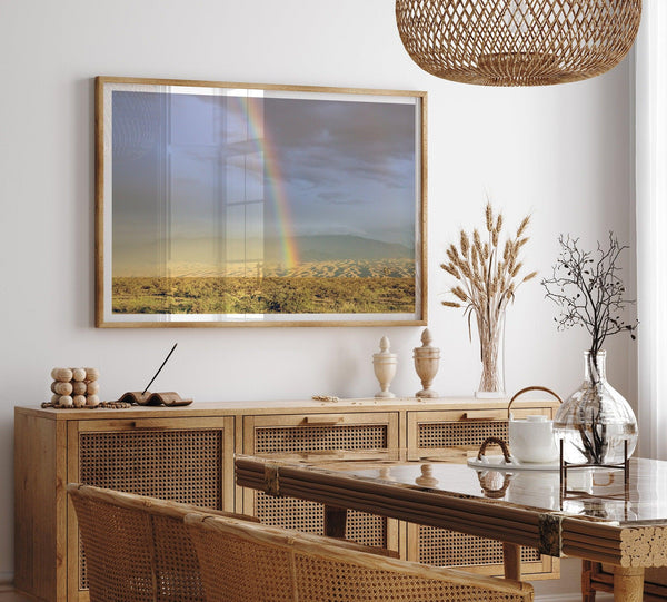 A fine art unframed or framed Arizona desert print showcasing a beautiful rainbow and cloudy sky in the middle of the desert landscape.
