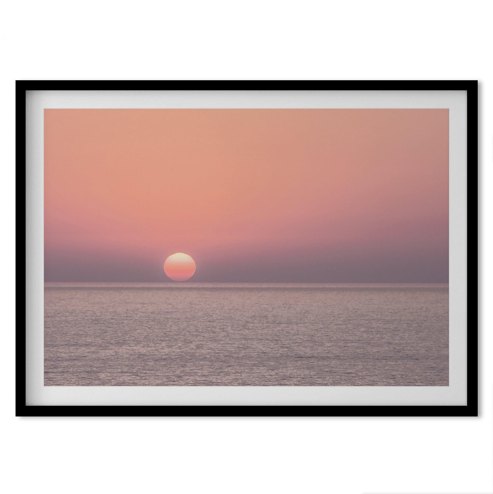 A fine art abstract ocean sunset print featuring rich shades of red, orange, and pink. This ocean wall art will add warmth and beauty to any room in your home.