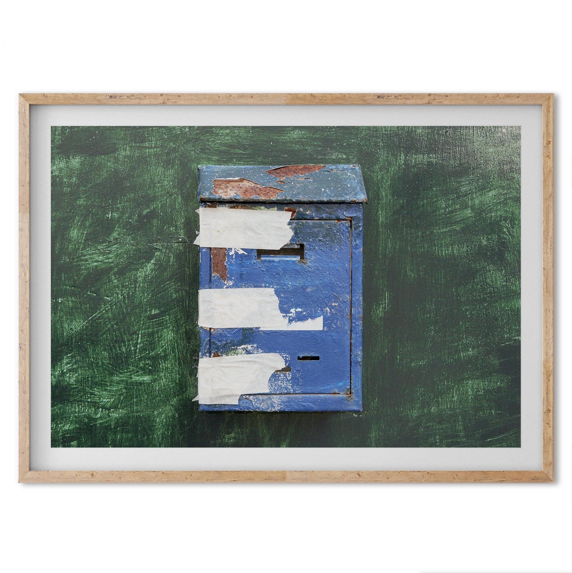 A fine art minimalist photography print of a rustic blue Mediterranean mail box on a green washed-out wall. great color addition to your wall decor.