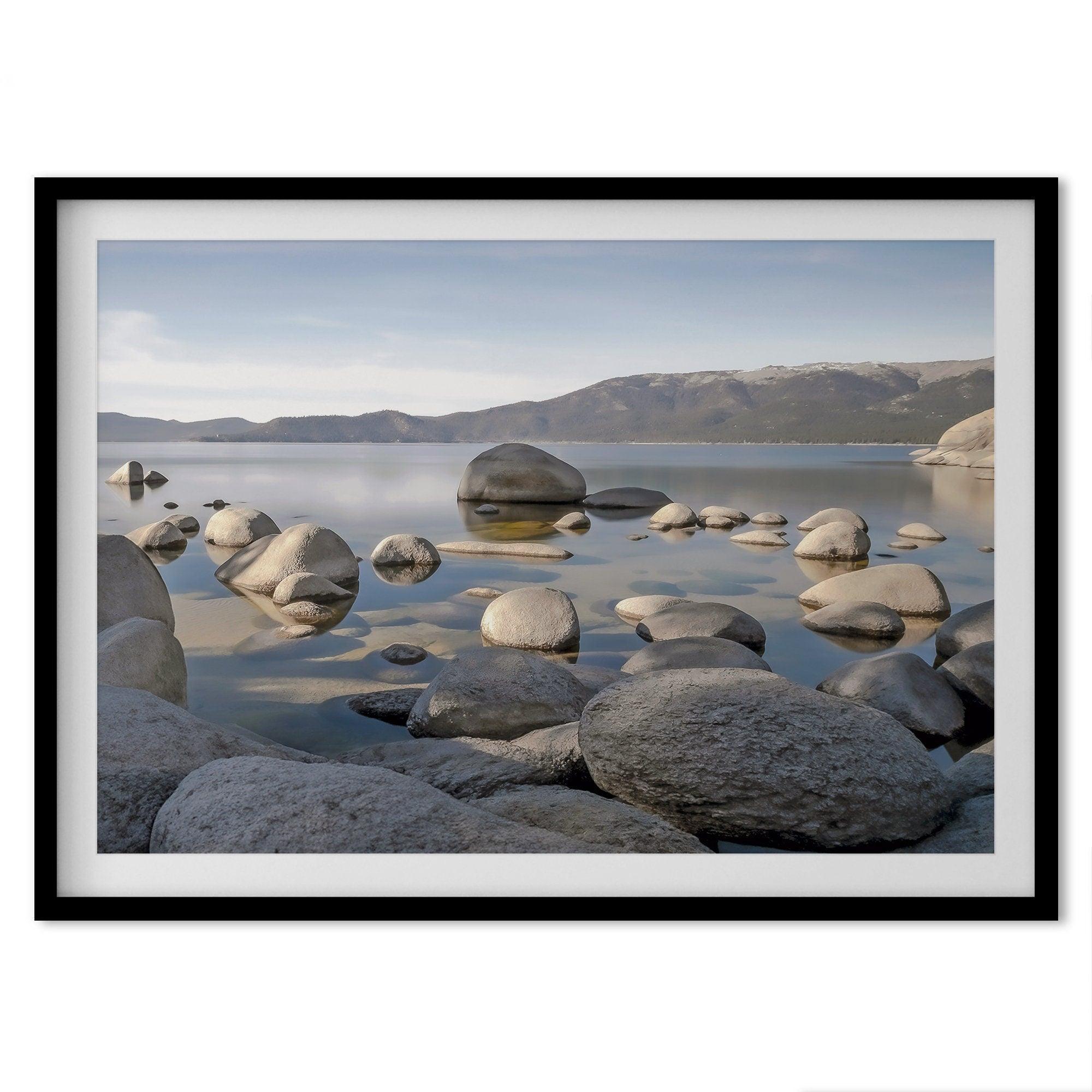 This breathtaking fine art Lake Tahoe print captures the perfect shape of the huge rocks that rise from the crystal-clear water, creating a beautiful contrast against the blue sky and the distant mountain range.