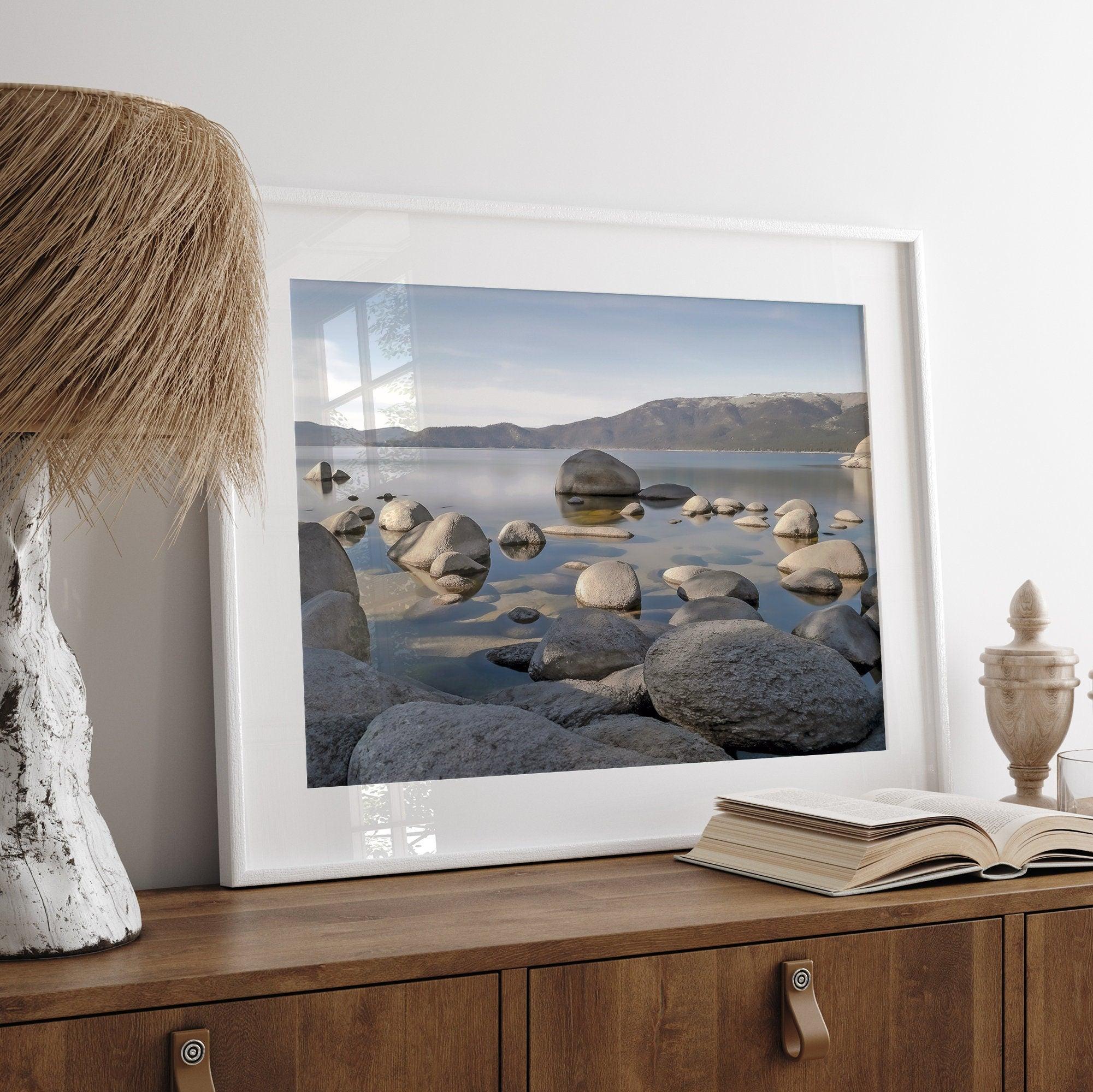 This breathtaking fine art Lake Tahoe print captures the perfect shape of the huge rocks that rise from the crystal-clear water, creating a beautiful contrast against the blue sky and the distant mountain range.