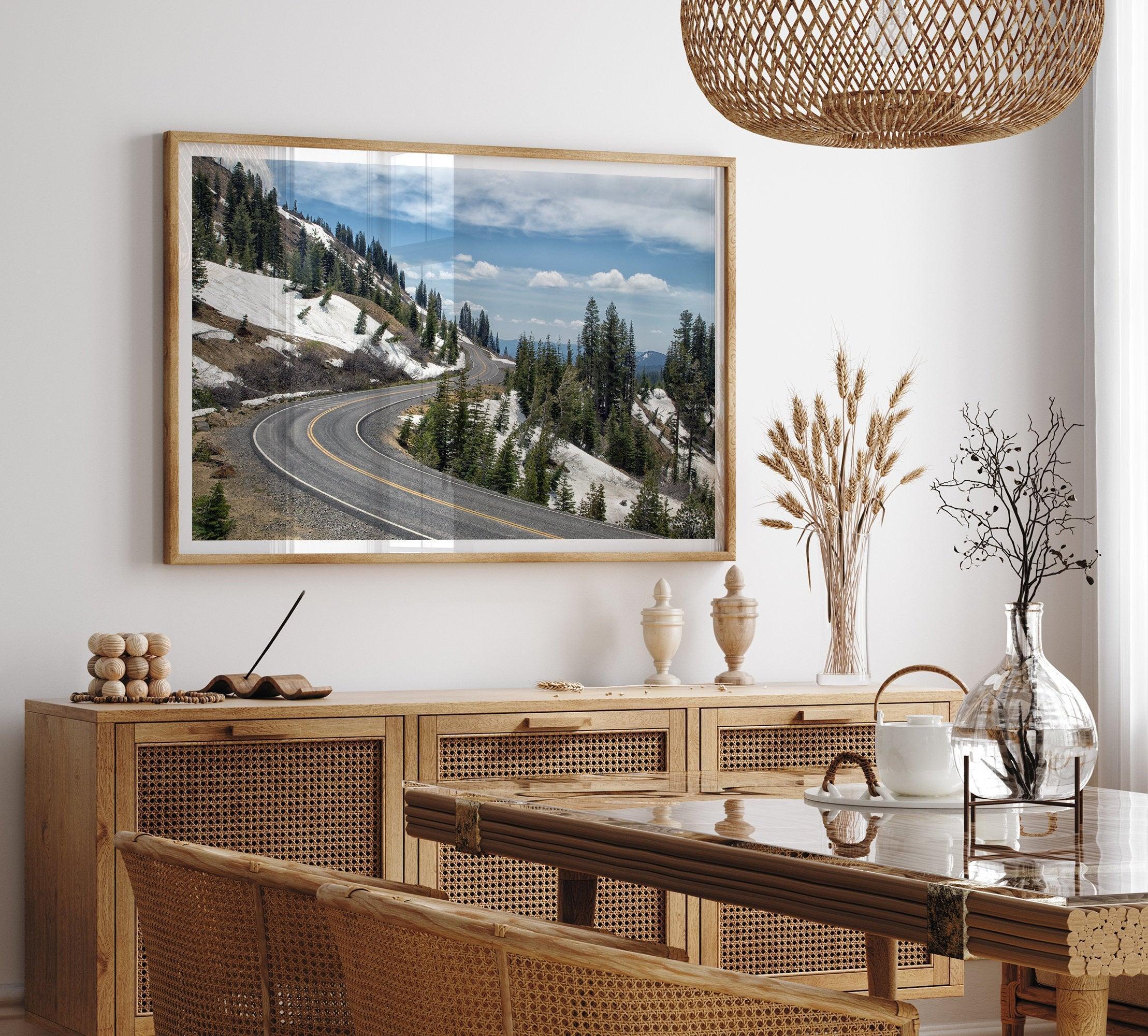 An unframed or framed fine art print of a mountain in Lassen National Park, Featuring a winding road through the lush forest and snow covered mountain.