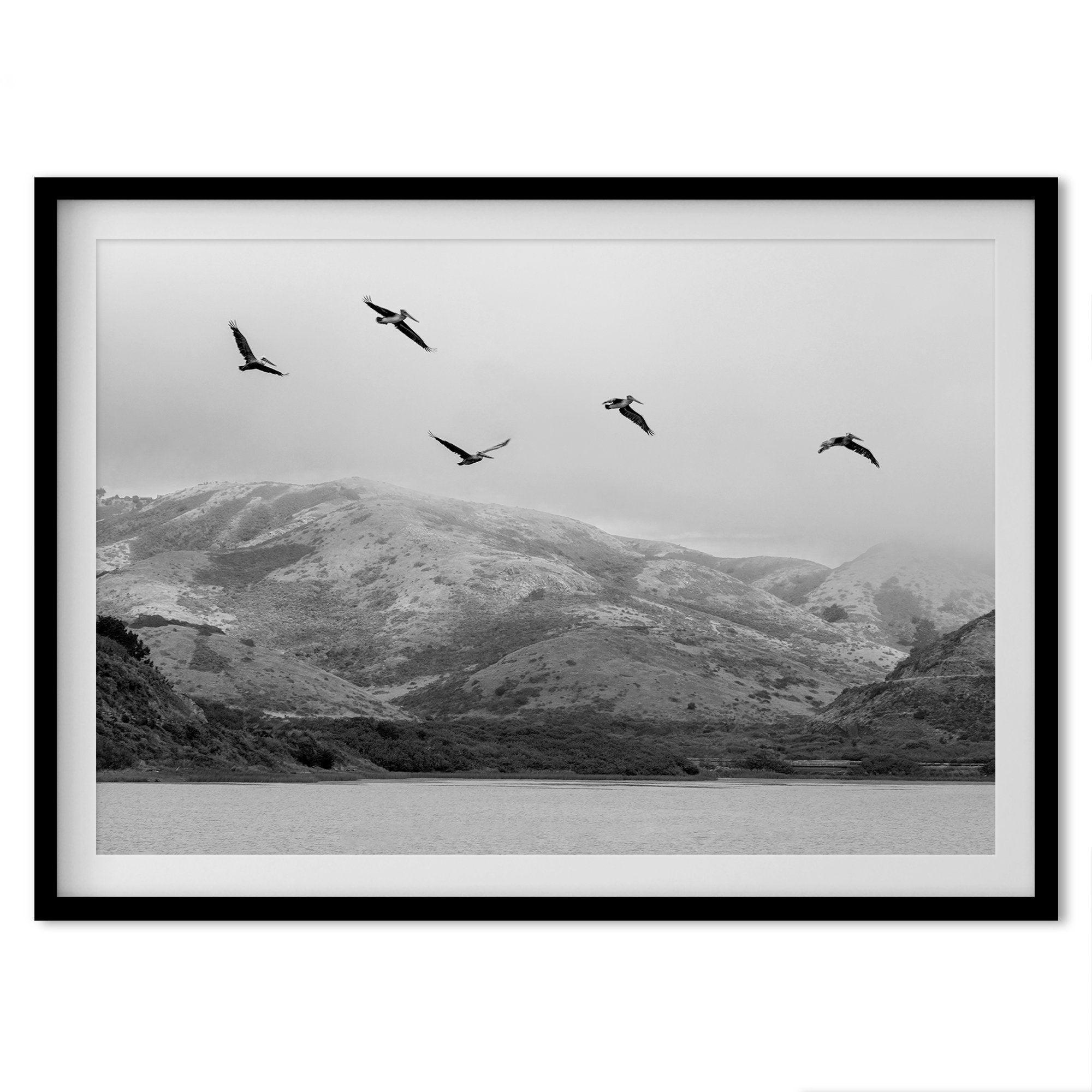 A Fine art black and white beach print of a California beach lagoon with foggy coastal mountains, and pelicans in flight - modern coastal wall art for beach house decor