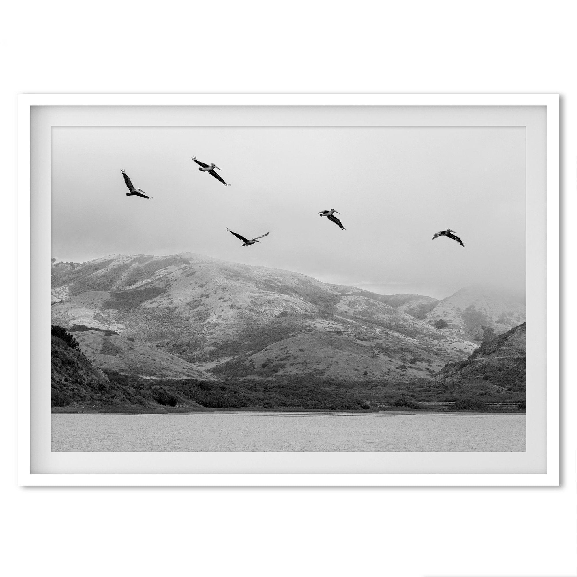 A Fine art black and white beach print of a California beach lagoon with foggy coastal mountains, and pelicans in flight - modern coastal wall art for beach house decor