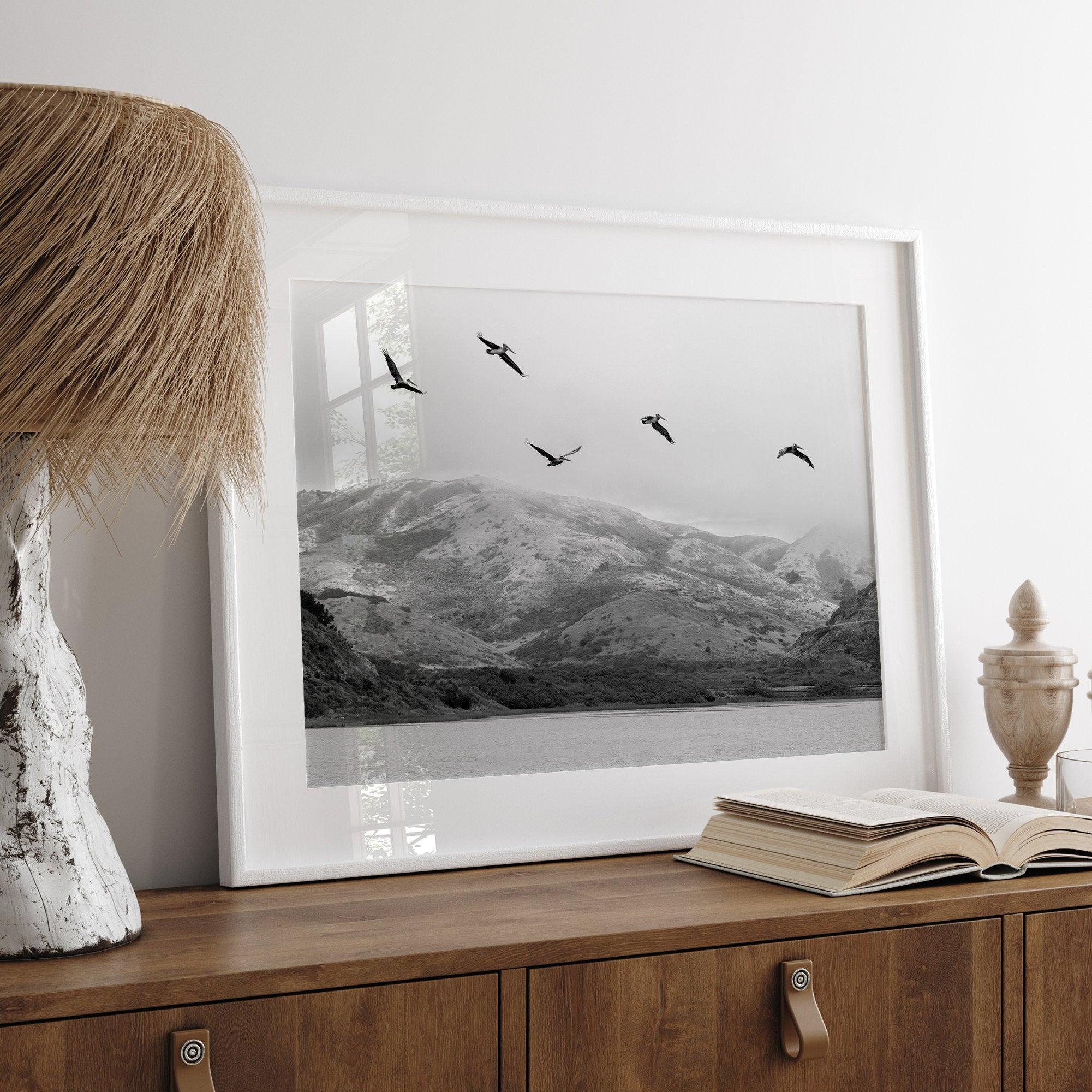 A Fine art black and white beach print of a California beach lagoon with foggy coastal mountains, and pelicans in flight - modern coastal wall art for beach house decor