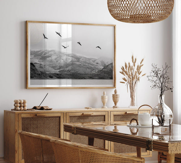 A Fine art black and white beach print of a California beach lagoon with foggy coastal mountains, and pelicans in flight - modern coastal wall art for beach house decor