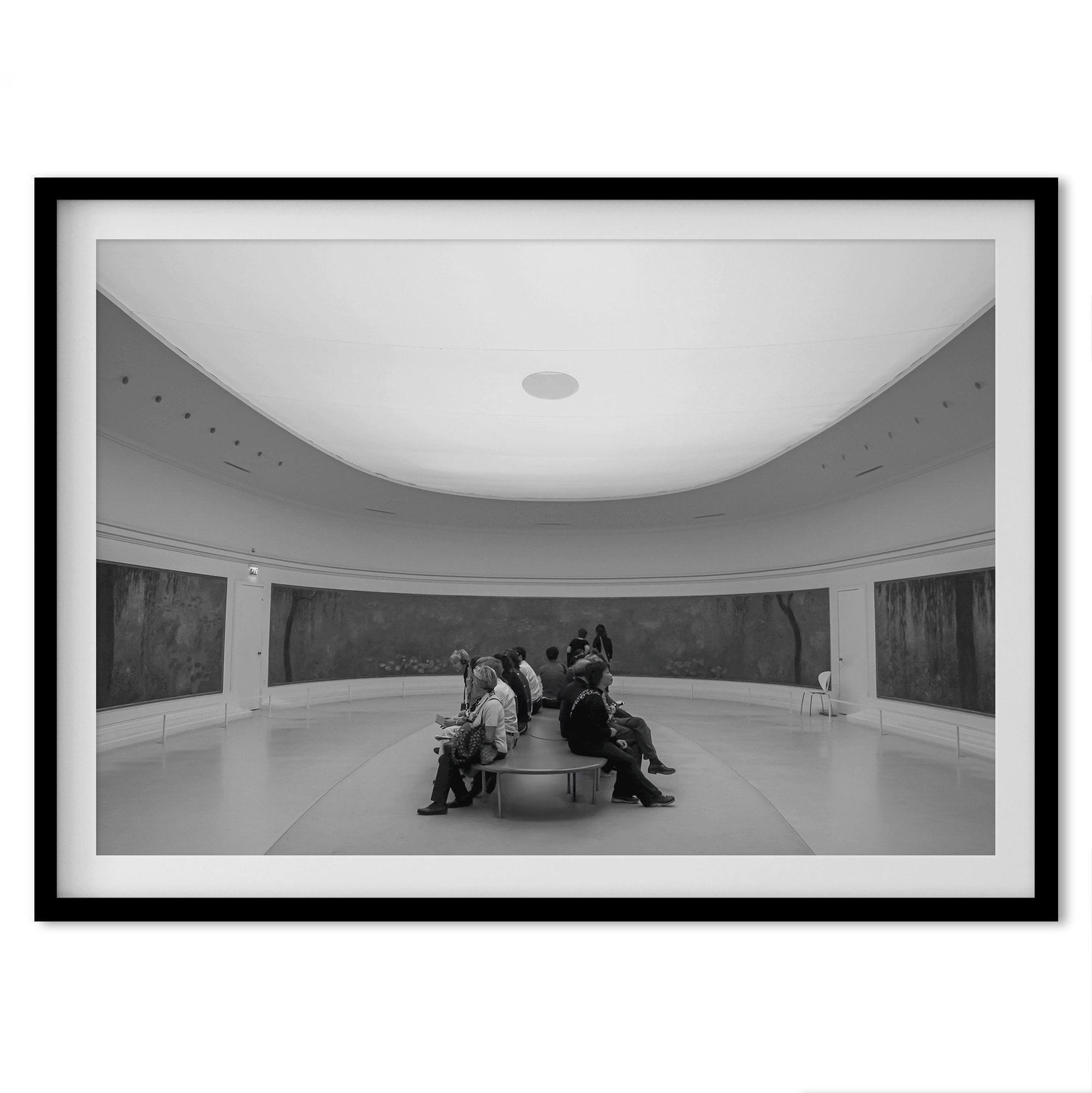 This unique black and white fine art Paris photo print transports you to the heart of the Musée d'Orsay in Paris, the center of the Impressionist movement. This Paris wall art showcases spectators sitting in the middle of the Monet exhibition.