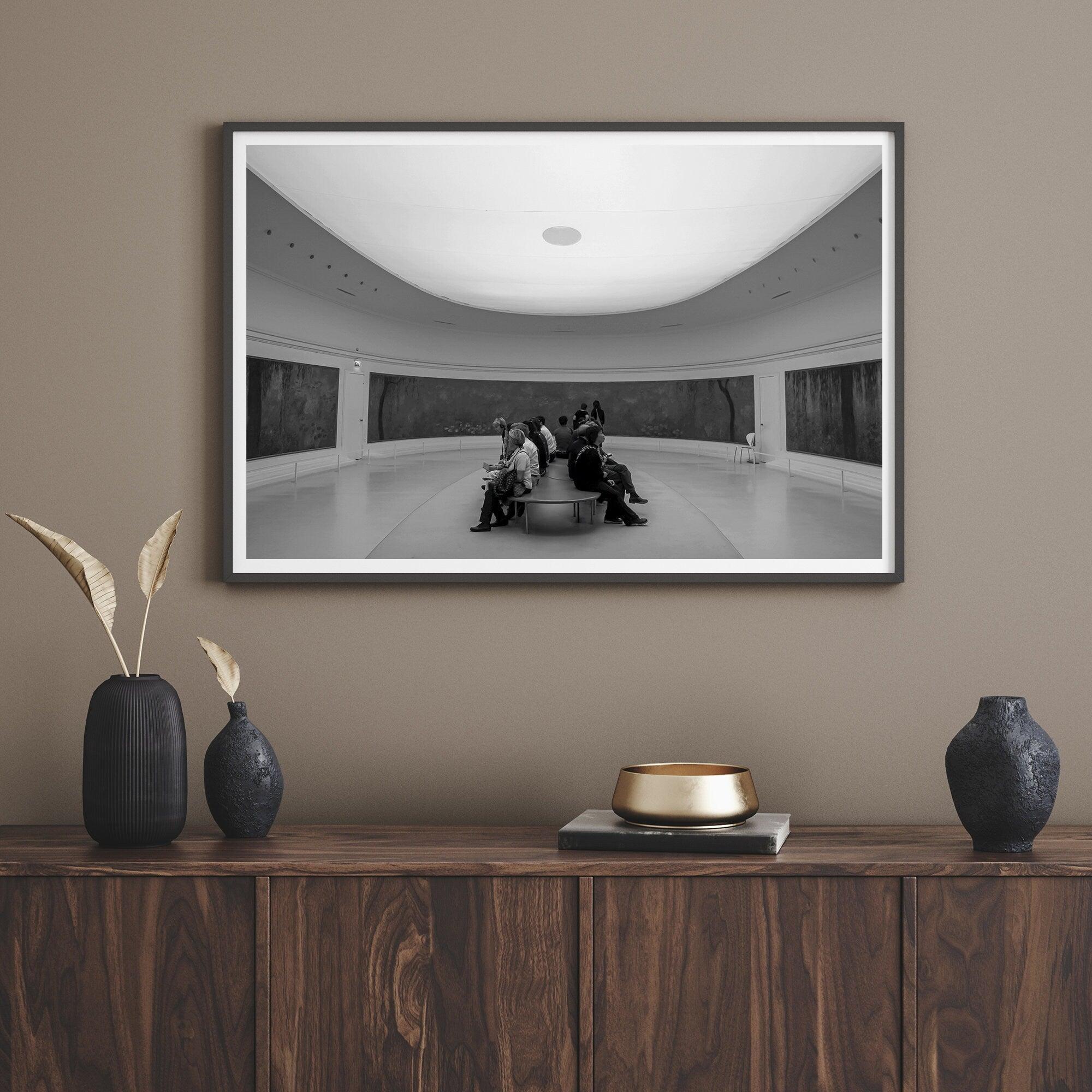 This unique black and white fine art Paris photo print transports you to the heart of the Musée d'Orsay in Paris, the center of the Impressionist movement. This Paris wall art showcases spectators sitting in the middle of the Monet exhibition.