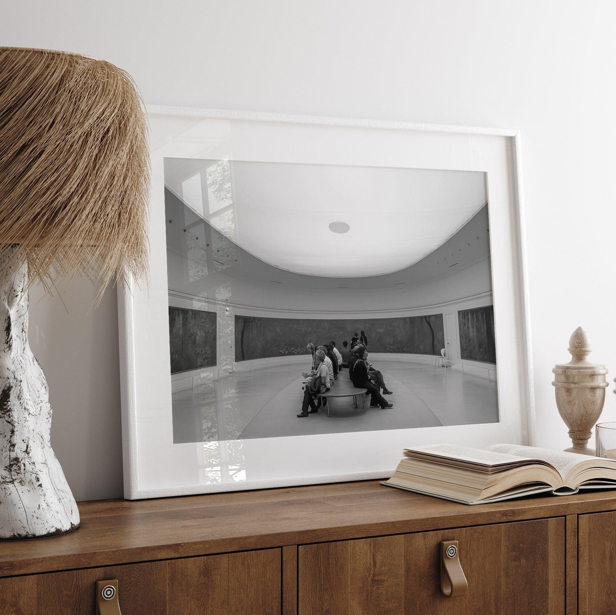 This unique black and white fine art Paris photo print transports you to the heart of the Musée d'Orsay in Paris, the center of the Impressionist movement. This Paris wall art showcases spectators sitting in the middle of the Monet exhibition.