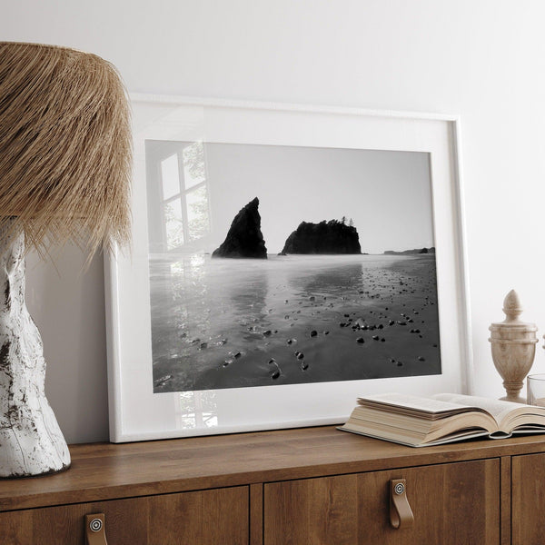 A fine art print of Ruby Beach in Olympic National Park, Washington. This black and white beach wall art features creamy waves in long exposure and dark-shaded towering rocks emerging from the ocean.