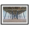A fine art boho style beach photography print featuring a view from below Pismo Beach Pier.