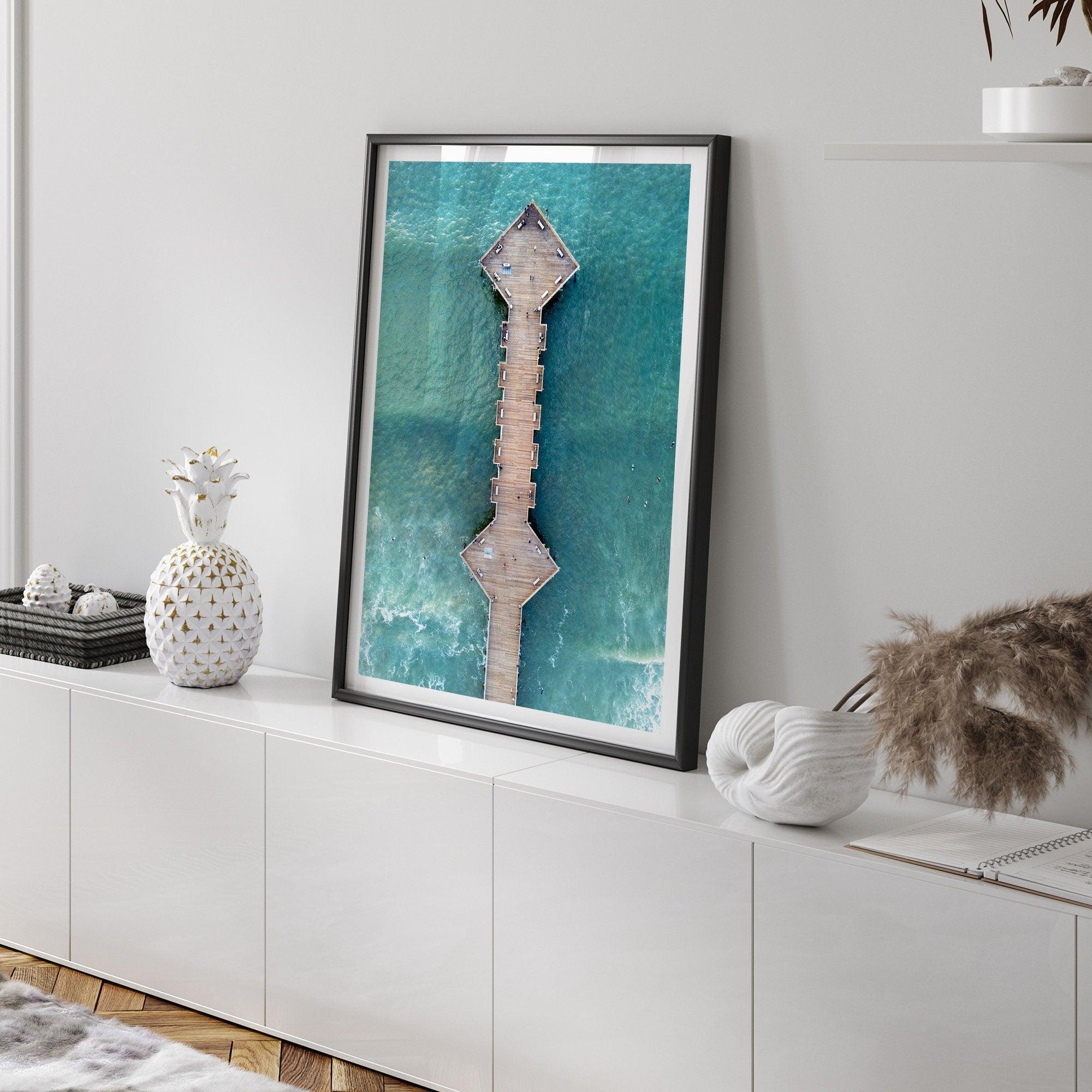 A fine art aerial beach pier photography pier. This ocean drone photography print was taken in Pismo Beach, California 300 feet above the ground. The result is minimalist geometrical wall art that brings out the beauty of the Pacific Ocean.