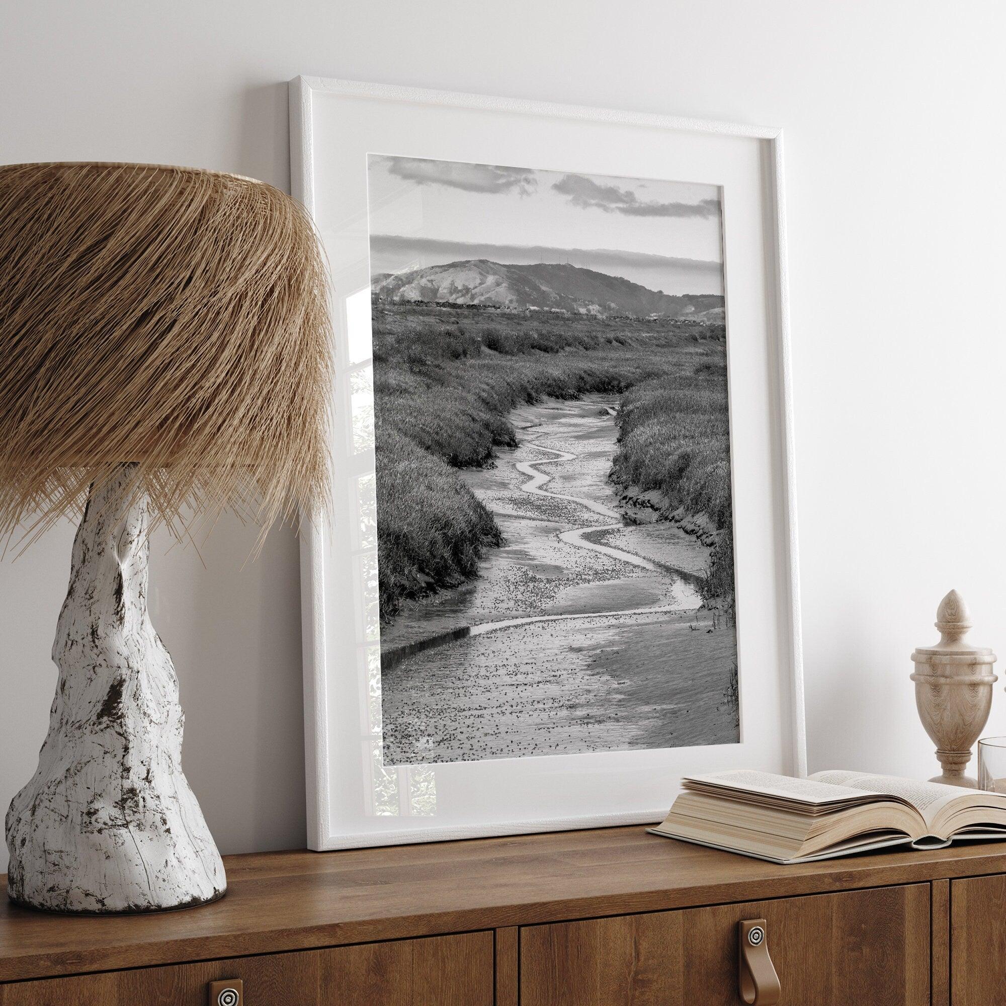 A captivating fine art black and white nature portrait print that transports viewers to the enchanting marshlands of California, where a winding little river weaves its way through a picturesque landscape.