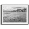 A fine art black and white ocean print featuring surfers paddling out to sea. Taken in Pismo beach, this beach wall art is perfect for beach houses or home decor.