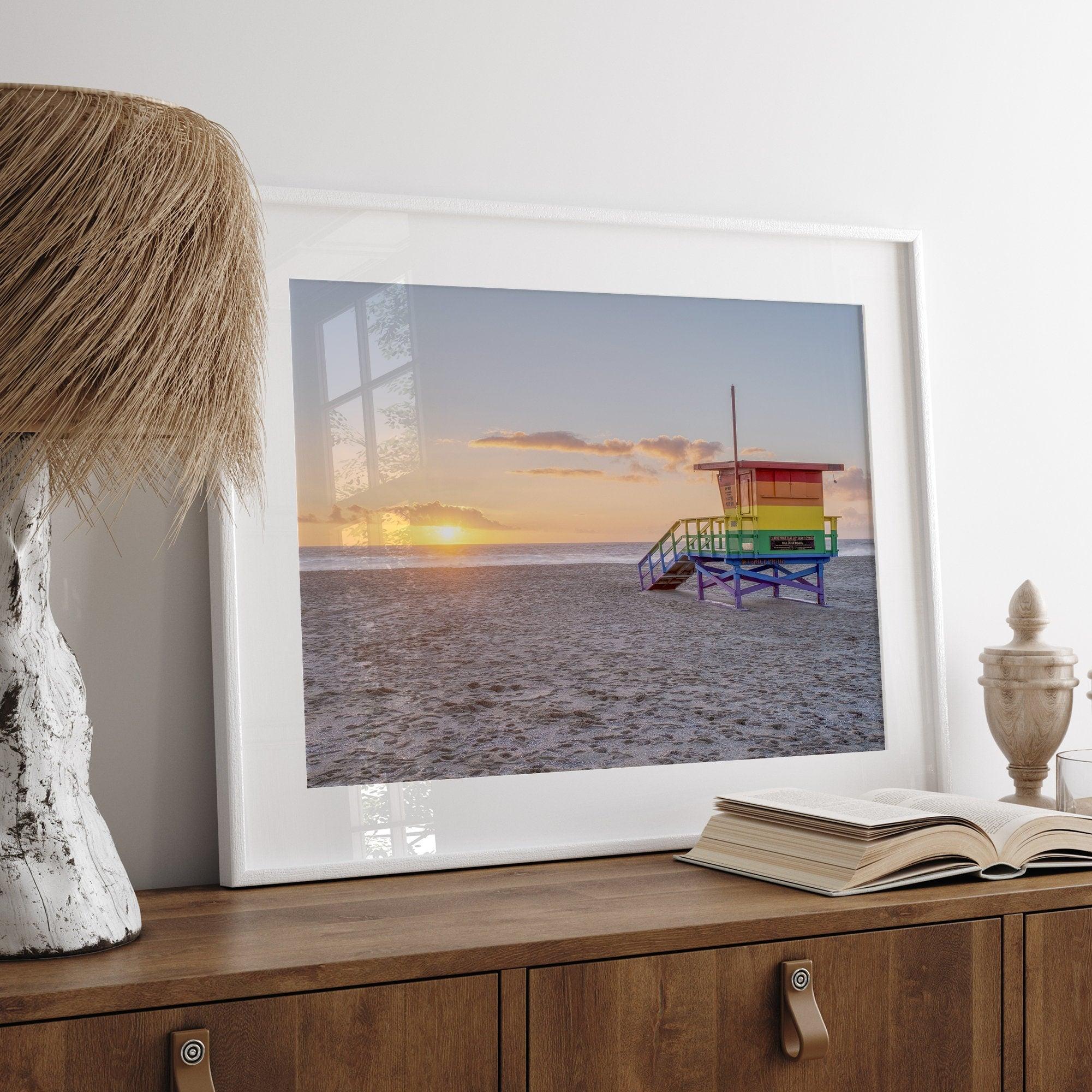 A fine art colorful Los Angeles print featuring Venice Beach at Sunset. This stunning California beach wall art features the famous lifeguard towers of Venice Beach at sunset with the ocean in the backdrop.