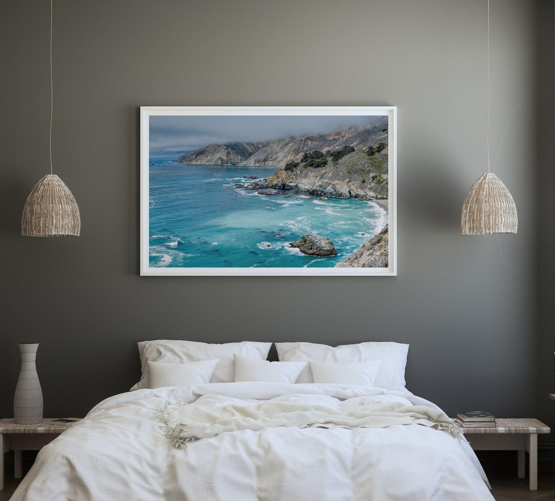 A fine art ocean print from Big Sur California featuring dramatic cliffs, the blue ocean and surf, and the Bixby bridge in the backdrop.