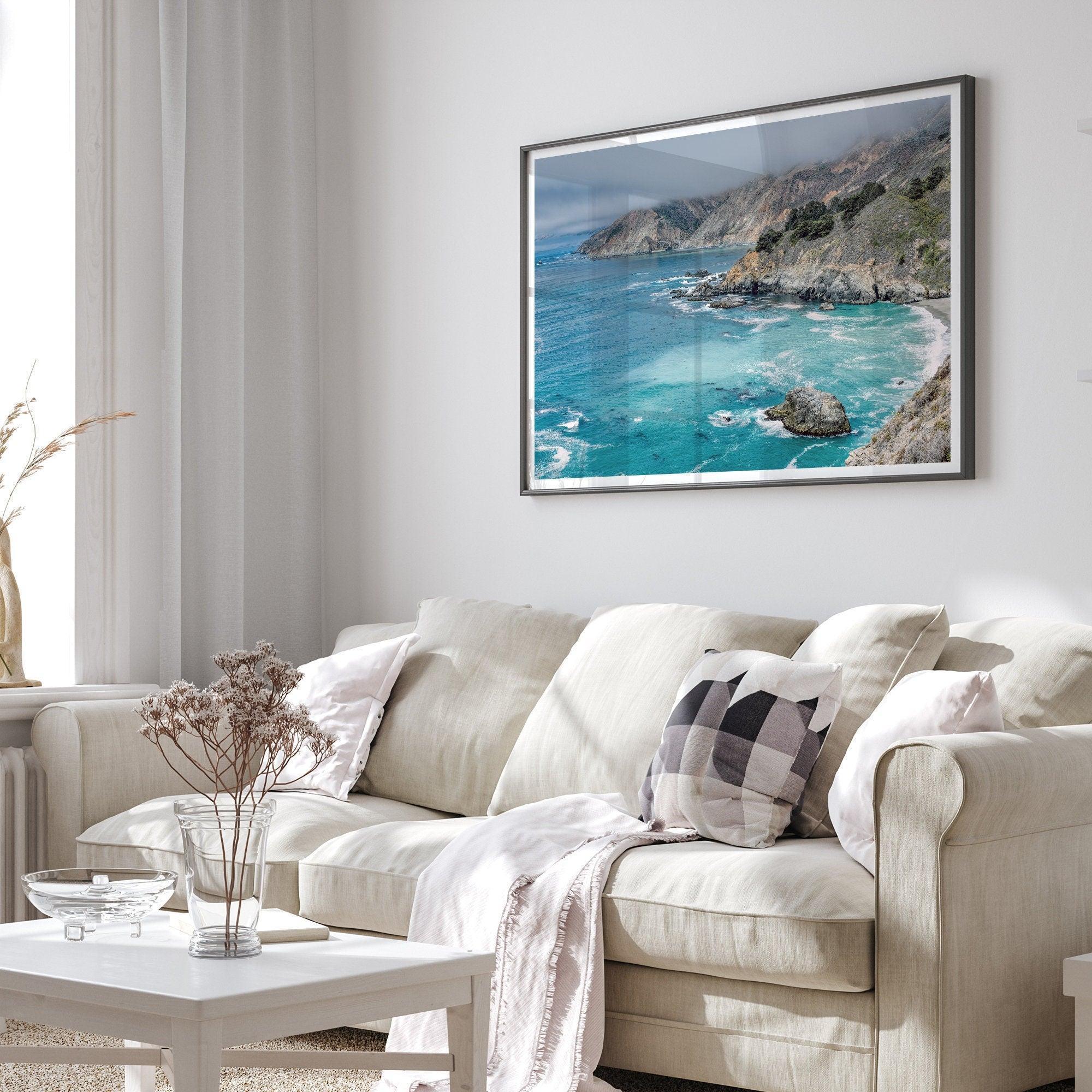 A fine art ocean print from Big Sur California featuring dramatic cliffs, the blue ocean and surf, and the Bixby bridge in the backdrop.