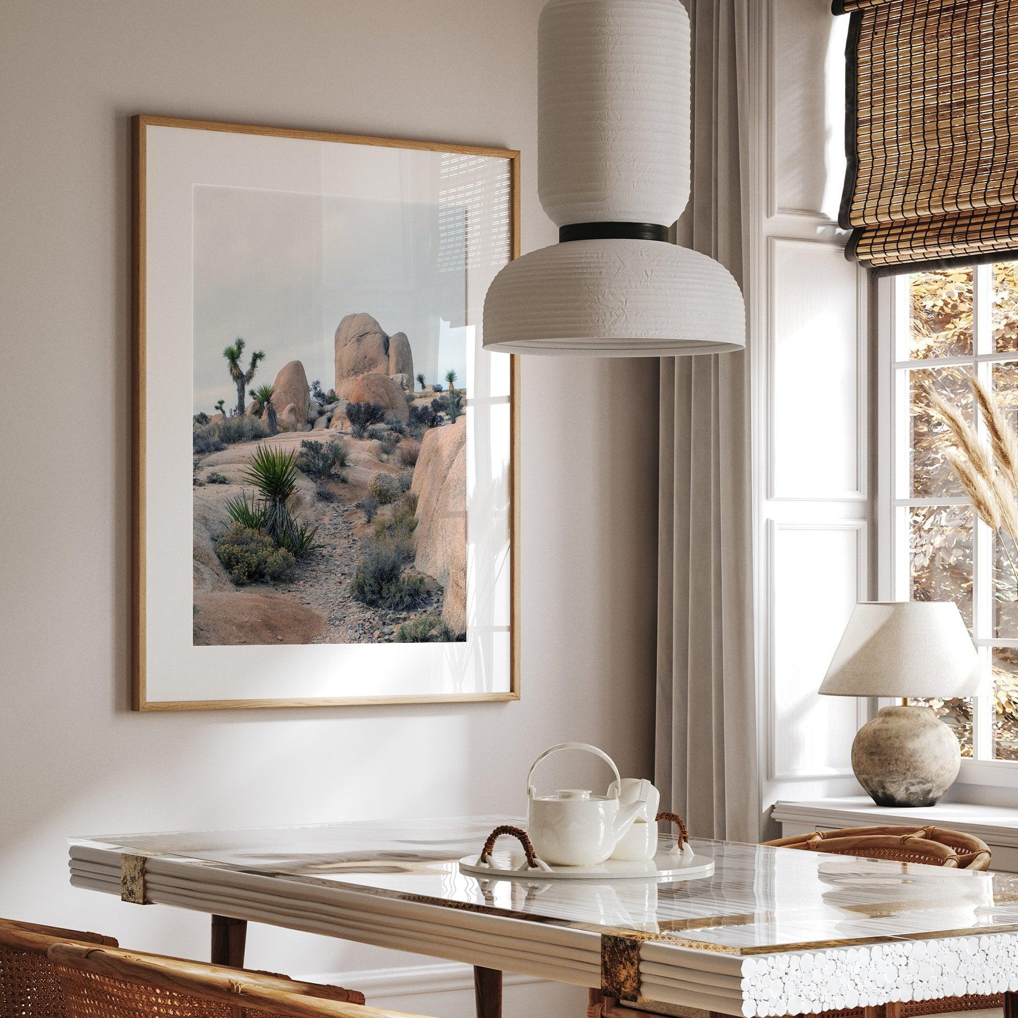 A fine art framed desert print featuring unique rock formations, desert plants, and Joshua Trees.