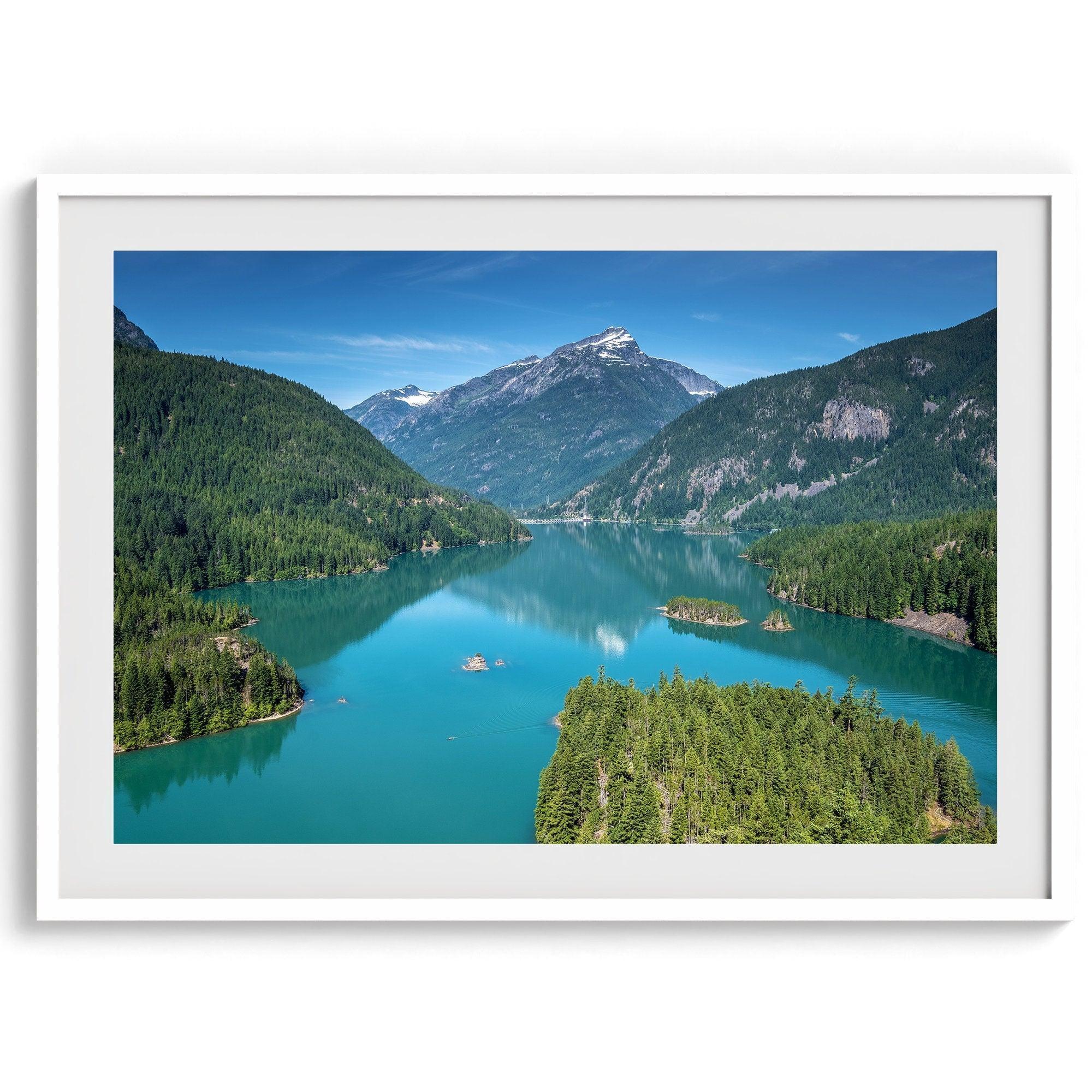 A fine art poster print of Diablo Lake in North Cascades National Park showcasing the deep blue water and the reflection of the surrounding mountains.