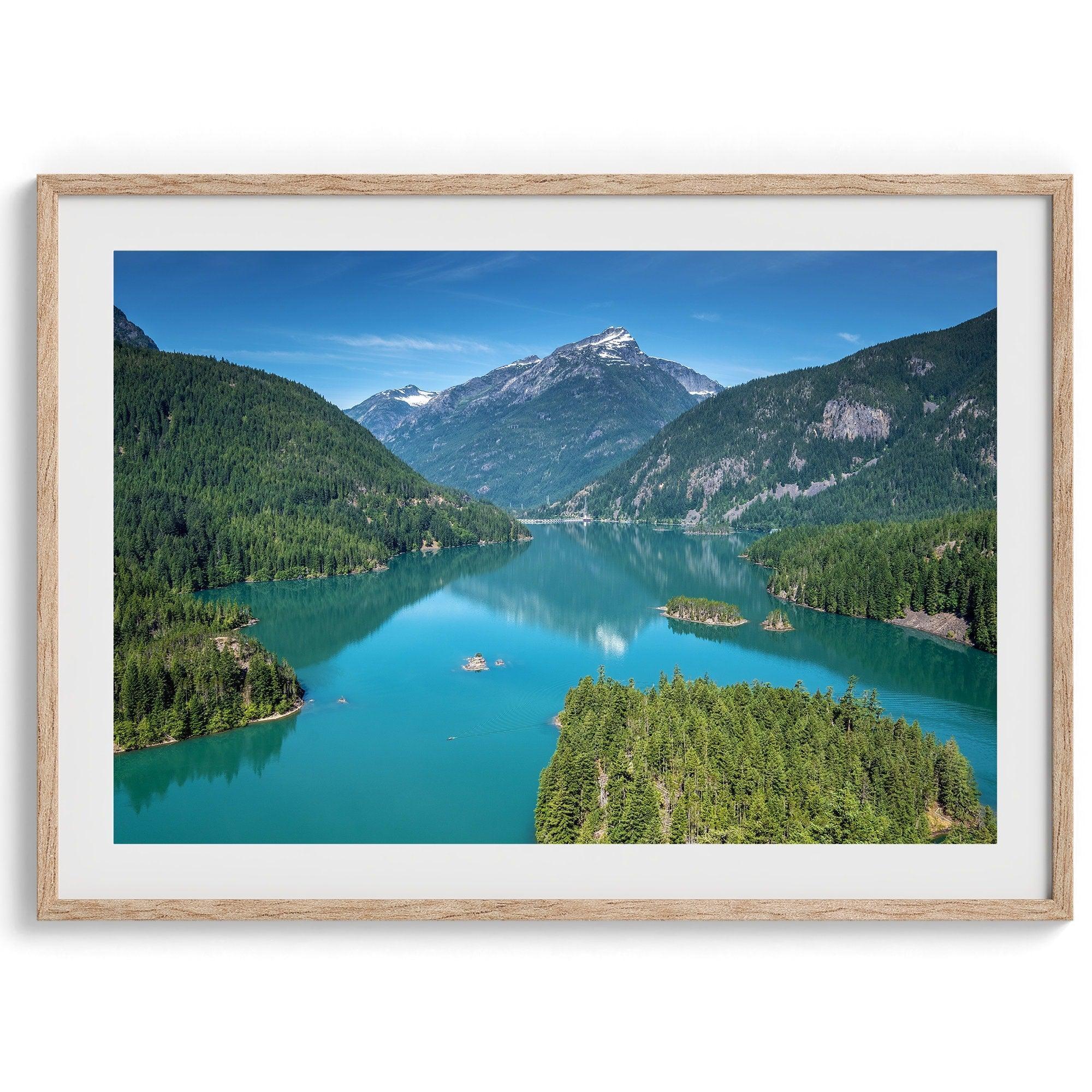 A fine art poster print of Diablo Lake in North Cascades National Park showcasing the deep blue water and the reflection of the surrounding mountains.