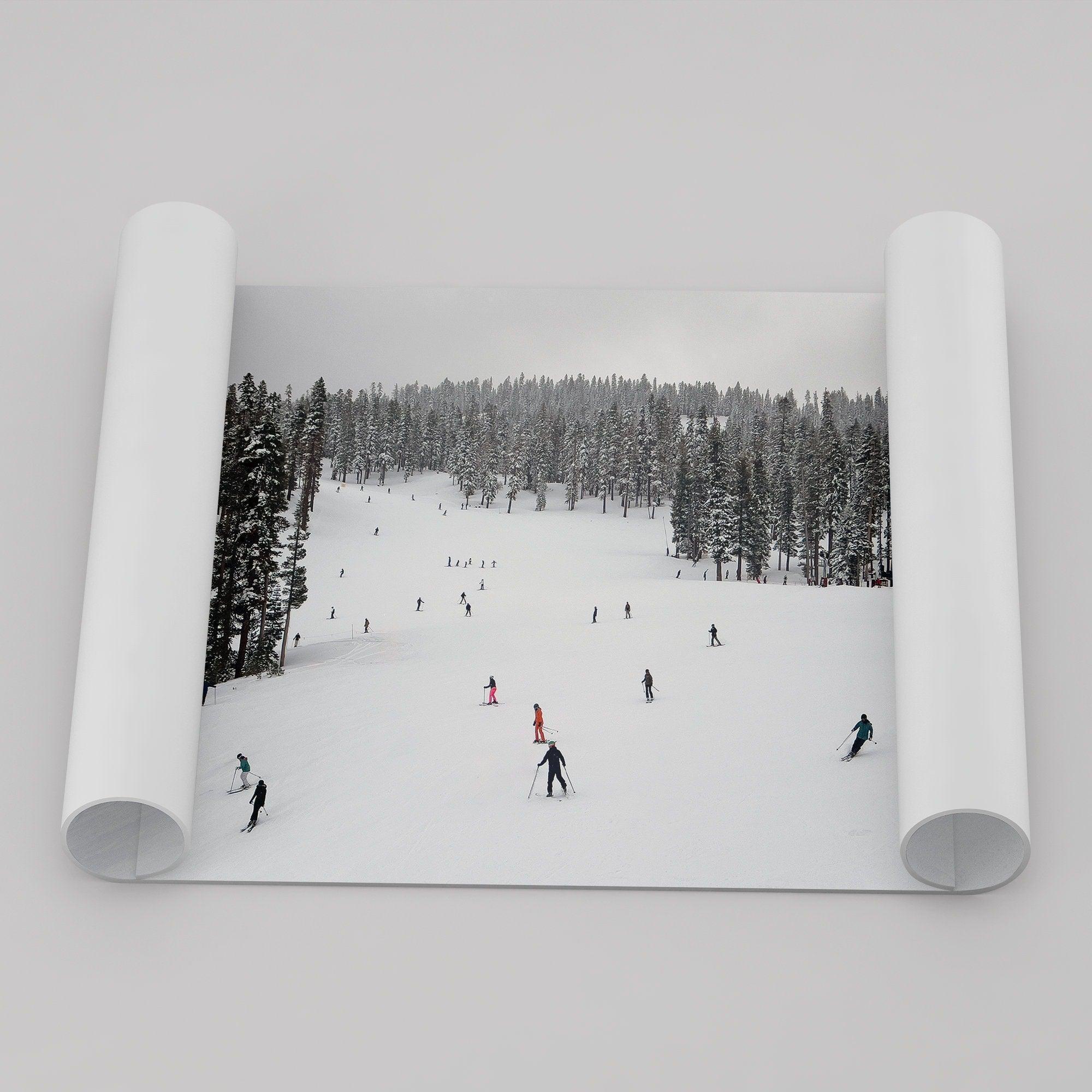 A fine art winter photography print of people skiing on the snow-covered Northstar Northern California mountain with snow-covered forest around.