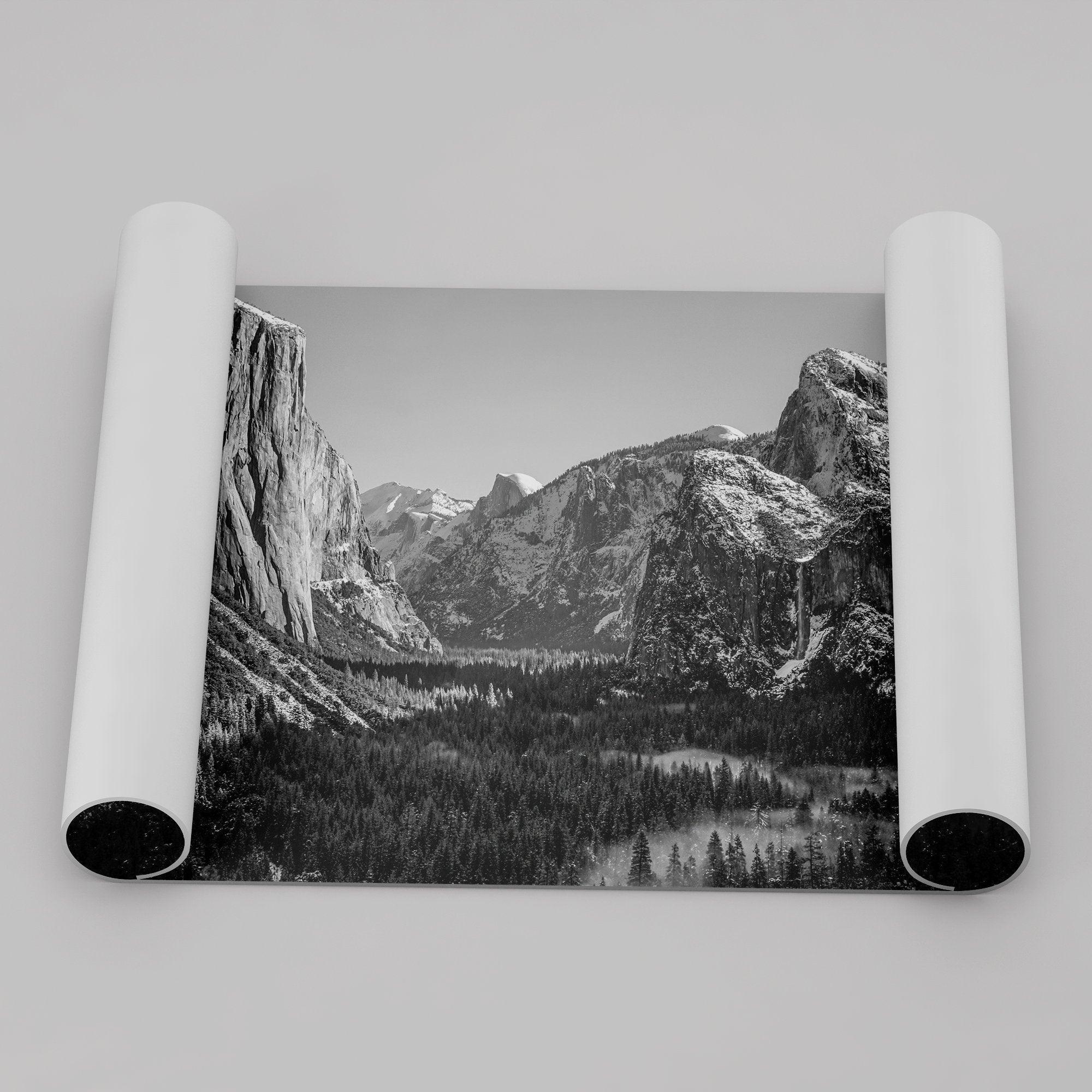 A fine art Yosemite Print featuring Yosemite Valley covered in snow in winter and a beautiful fog lays in the valley forest. This black and white mountain wall art is perfect for nature and fine art lovers.