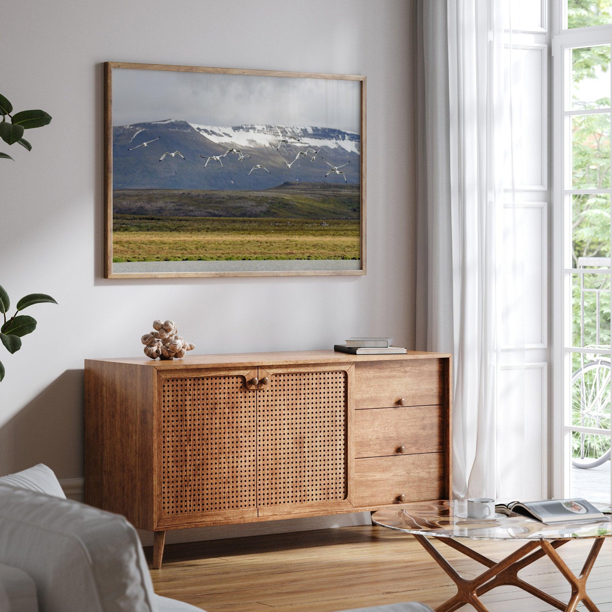 This fine art mountain print features Black-legged Kittiwakes flying over a lake with snow-covered mountains in the backdrop. Taken in Iceland.