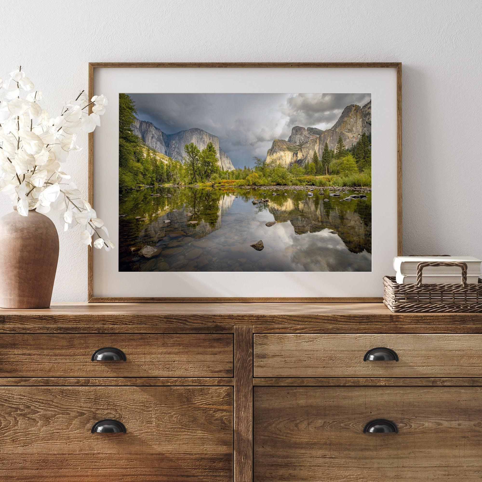 A stunning framed large Yosemite National Park print that shows the breathtaking valley at sunset with its mountains, rivers, forests, and waterfalls. A truly mesmerizing landscape that is as perfect as your wall decor as it is a special gift.