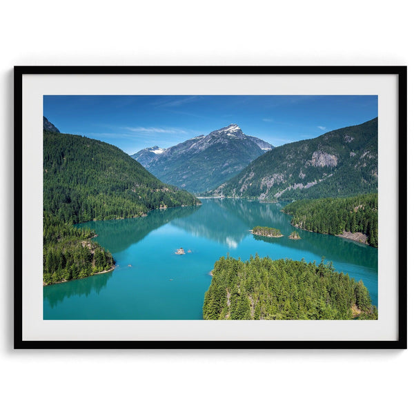 A fine art poster print of Diablo Lake in North Cascades National Park showcasing the deep blue water and the reflection of the surrounding mountains.