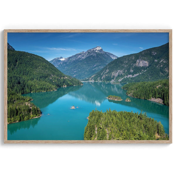 A fine art poster print of Diablo Lake in North Cascades National Park showcasing the deep blue water and the reflection of the surrounding mountains.