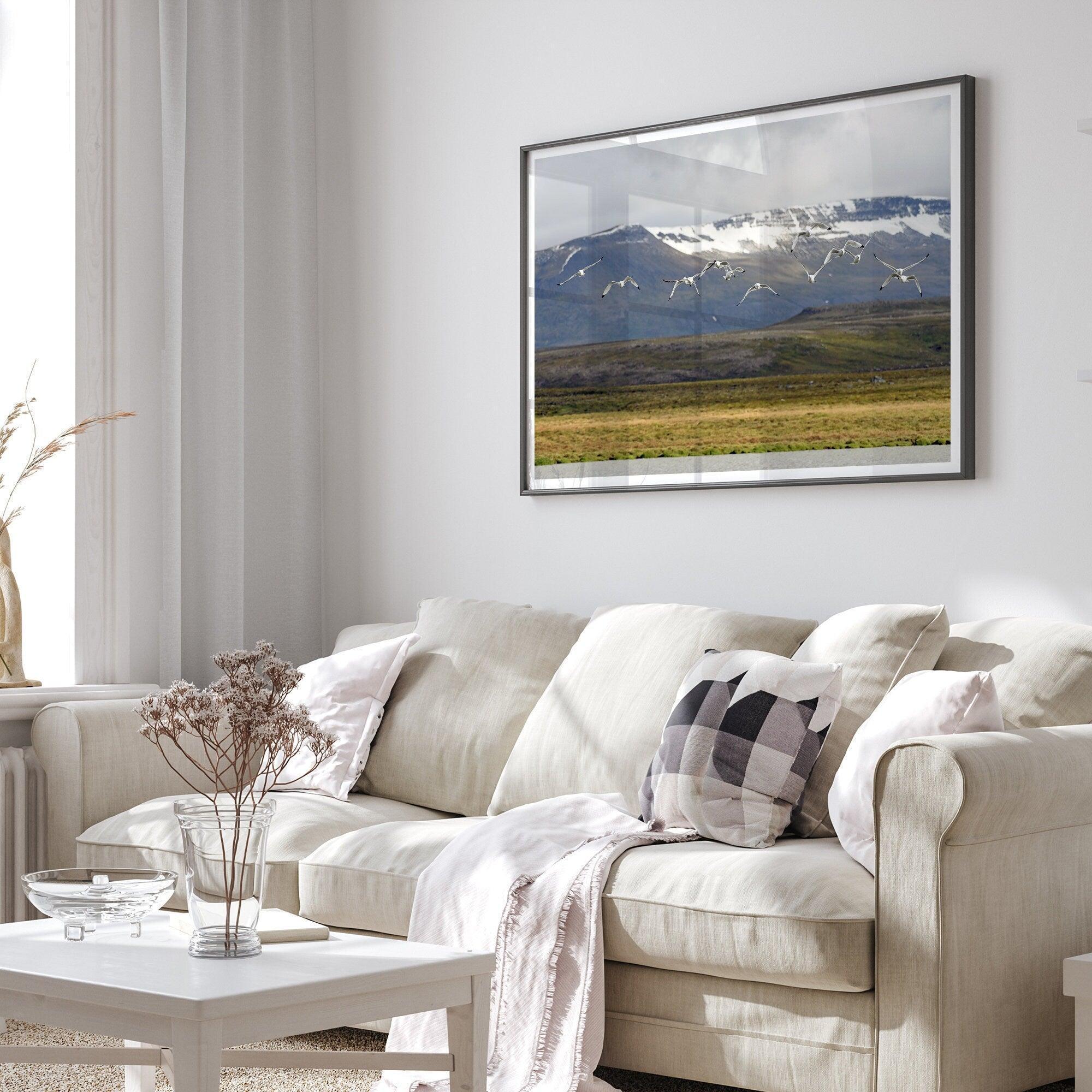 This fine art mountain print features Black-legged Kittiwakes flying over a lake with snow-covered mountains in the backdrop. Taken in Iceland.