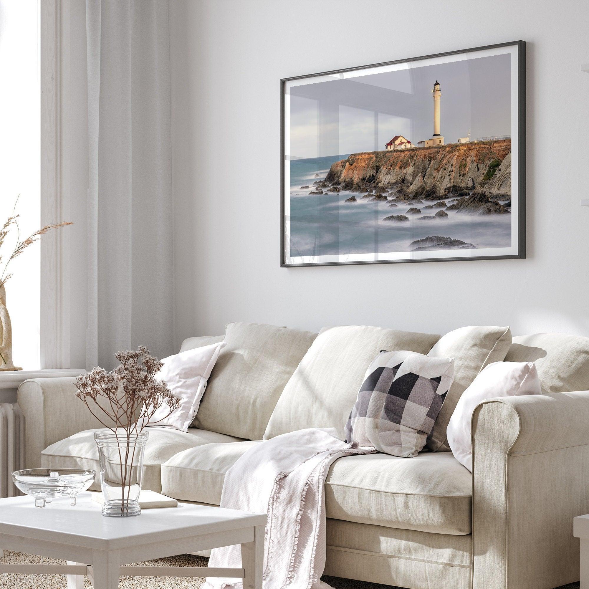 Long exposure fine art photography print of Pigeon Point Lighthouse at sunset. Golden light illuminates the lighthouse and cliffs, while the ocean surf crashes against the rocks in a creamy blur.