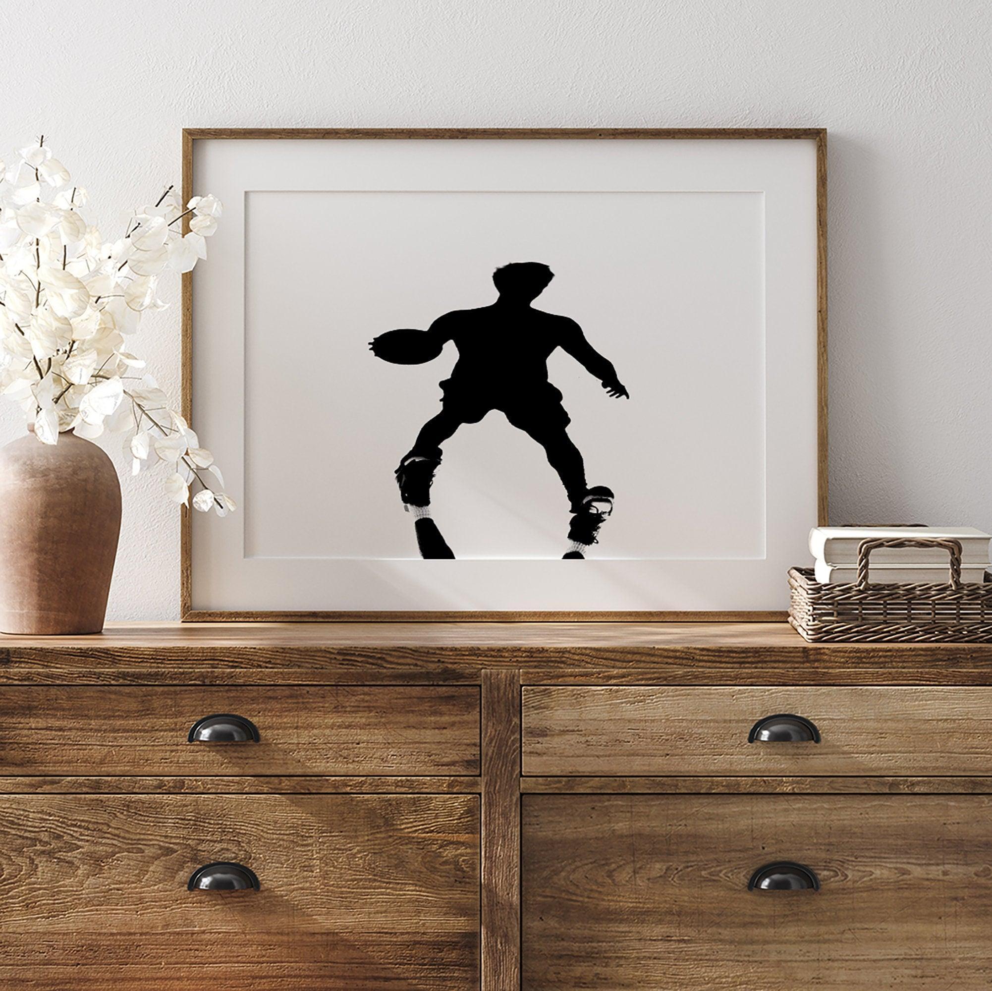 Black and white fine art photography poster print of a basketball player's shadow dribbling a ball on a sunny court.