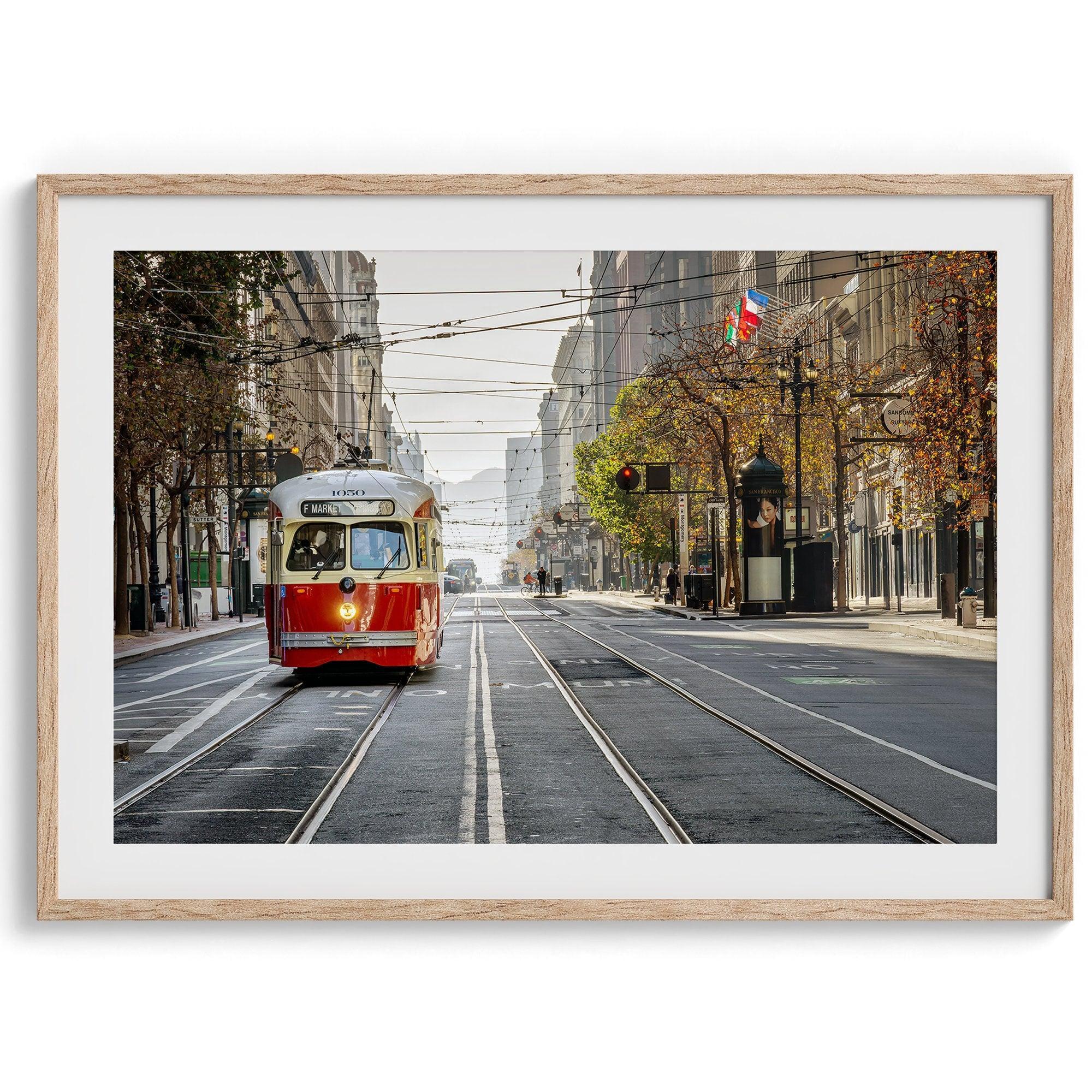 Fine art photograph of a cable car on Market Street in San Francisco, during golden hour. The image shows SF architecture, people, and the interplay of light and shadow.