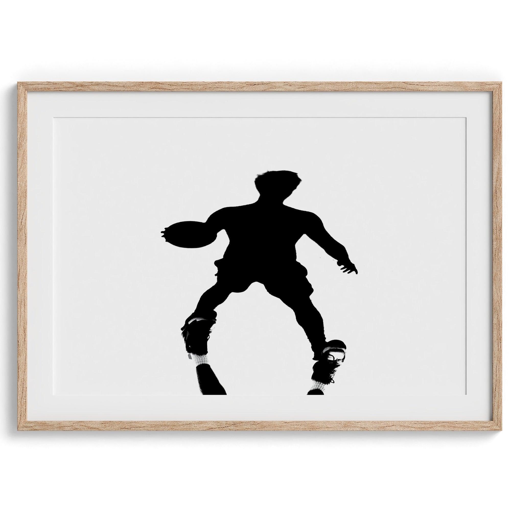 Black and white fine art photography poster print of a basketball player's shadow dribbling a ball on a sunny court.